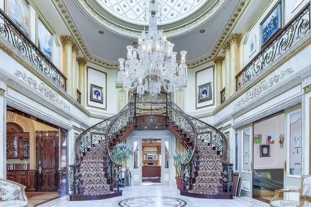 a large building with a clock on the balcony