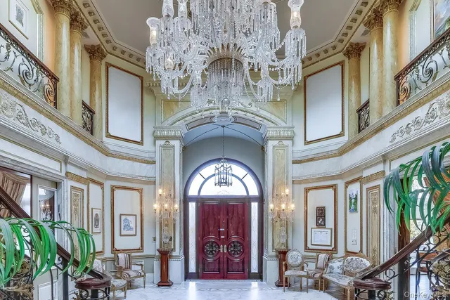 a view of a hallway with chandelier