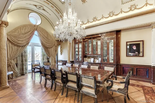 a view of a dining room with furniture and a chandelier