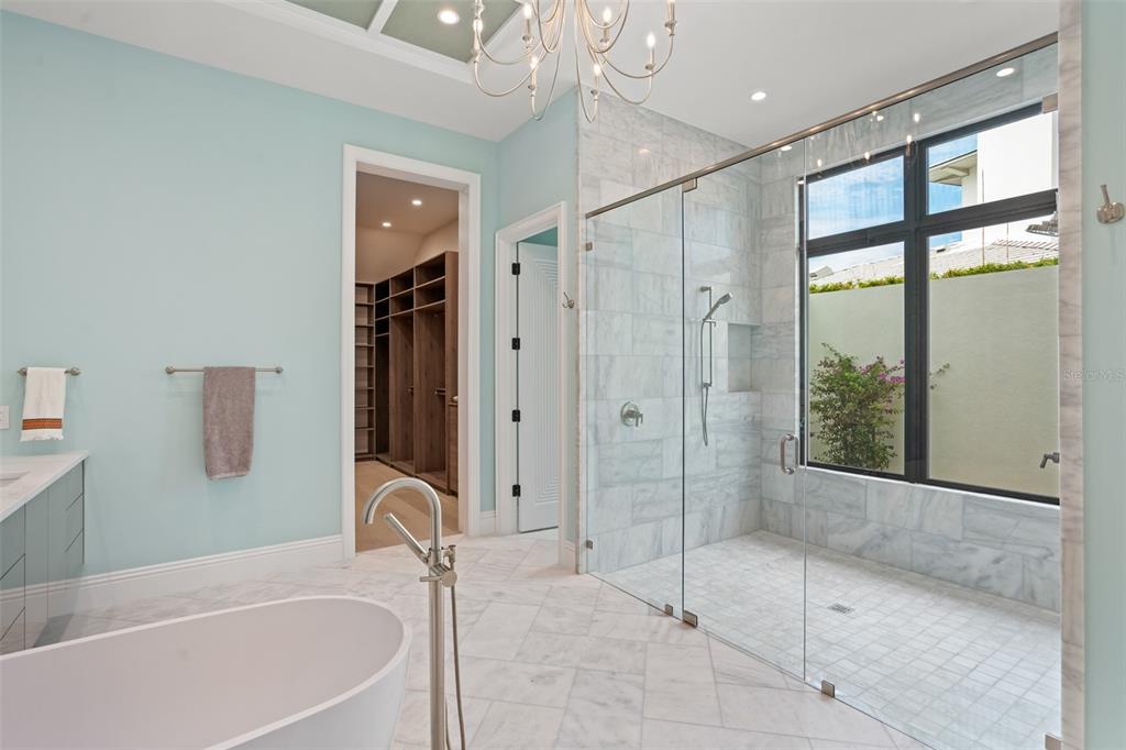 10065 Autumn Mist Lane Orlando, FL 32836 - Photo 16 of 65 a bathroom with a granite countertop tub shower and mirror