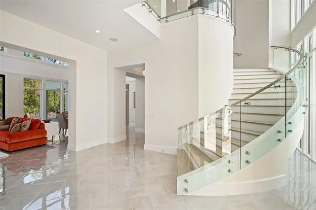 a living room with furniture and a floor to ceiling window
