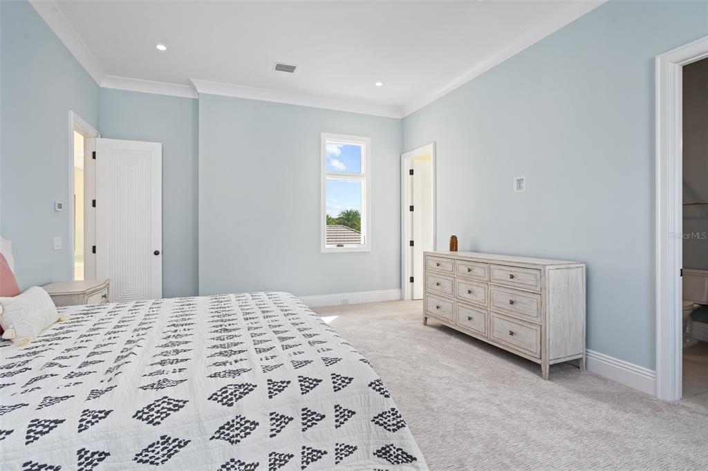 10065 Autumn Mist Lane Orlando, FL 32836 - Photo 44 of 65 a bedroom with a bed and a dresser