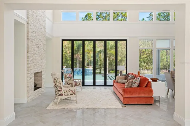 a dining room with furniture and a floor to ceiling window