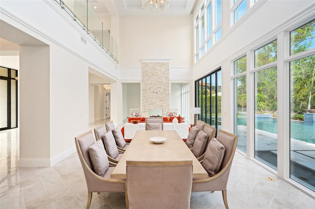 10065 Autumn Mist Lane Orlando, FL 32836 - Photo 8 of 65 a dining room with furniture and a floor to ceiling window