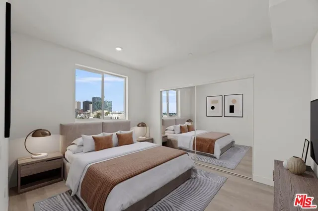 a bedroom with two beds and painting on the wall