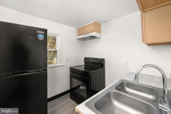 a kitchen with a refrigerator and a sink