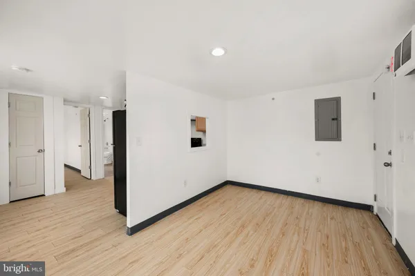 a view of an empty room with wooden floor