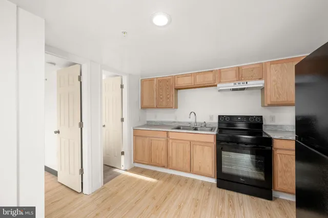 a kitchen with granite countertop stainless steel appliances and wooden cabinets