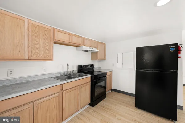 a kitchen with a sink and a refrigerator