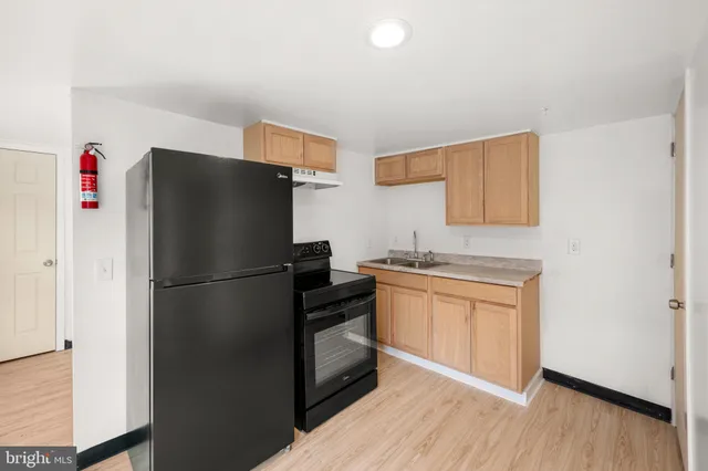a white refrigerator freezer sitting inside of a kitchen