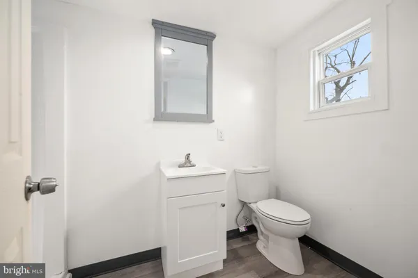 a white toilet sitting next to a bathroom sink