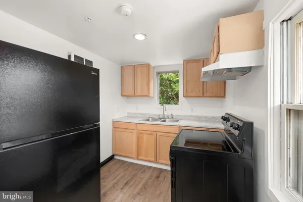 a kitchen with a sink stainless steel appliances and cabinets