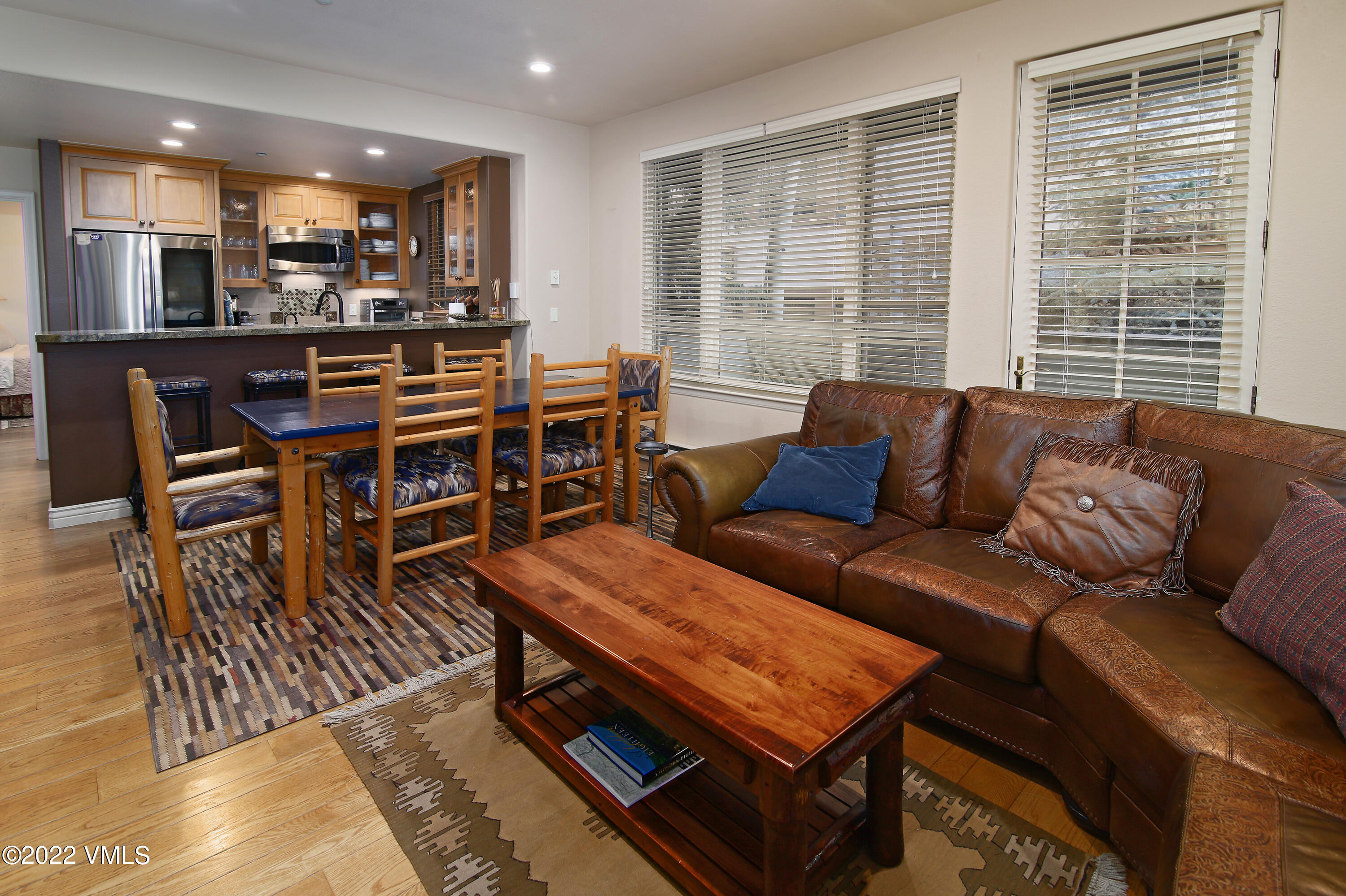 627 Sawatch Drive, Unit 201 Edwards, CO 81632 - Photo 1 of 17 a living room with furniture a large window and a dining table