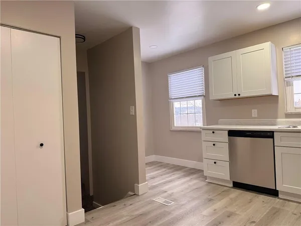 a kitchen with a refrigerator stove and microwave