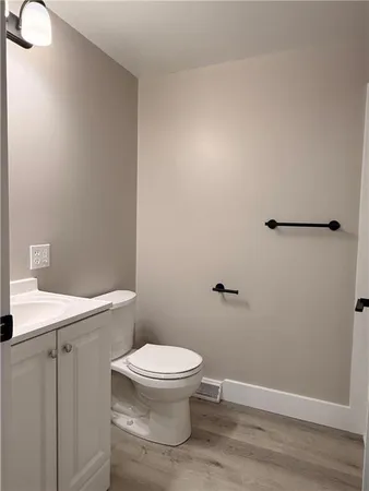 a white toilet sitting next to a shower