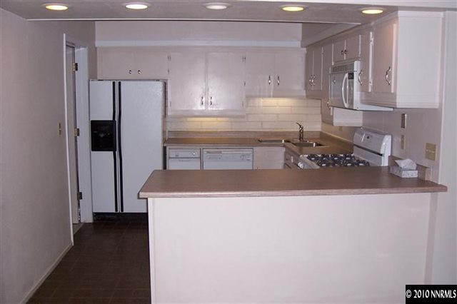 3921 Greenbriar Court Reno, NV 89509 - Photo 2 of 9 a kitchen with a refrigerator and a sink