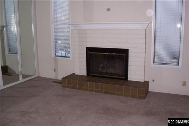 3921 Greenbriar Court Reno, NV 89509 - Photo 3 of 9 a living room with furniture and a fireplace