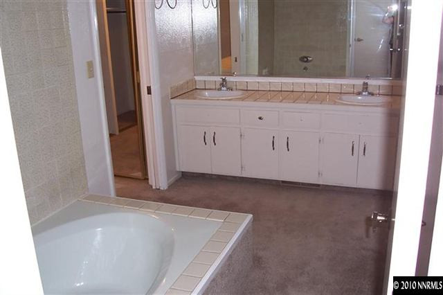 3921 Greenbriar Court Reno, NV 89509 - Photo 5 of 9 a bathroom with a bathtub sink and mirror