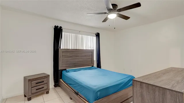 a room with a bed and a ceiling fan