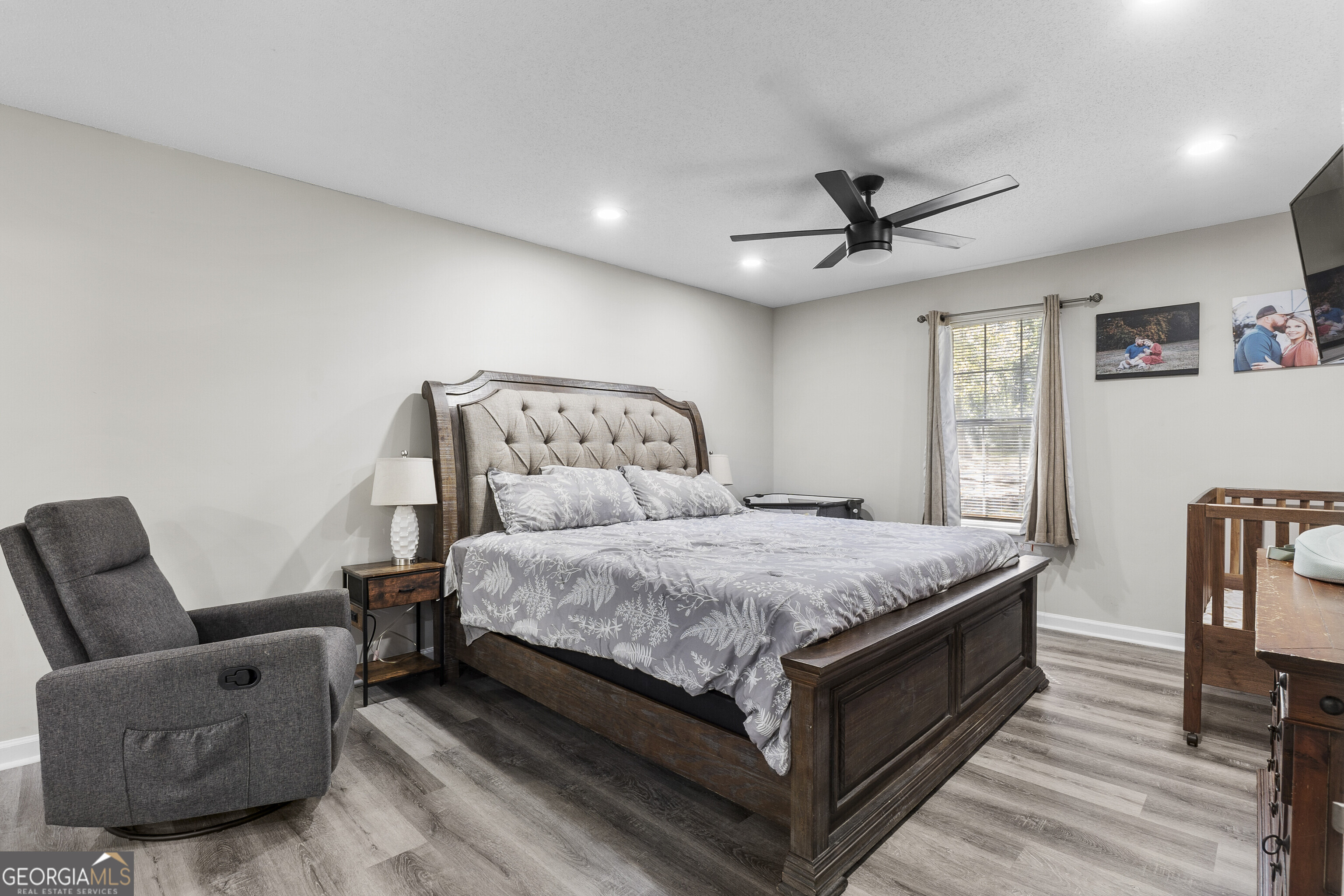 1412 Johnson Road Macon, GA 31220 - Photo 29 of 53 a bedroom with a bed a couch and a chandelier