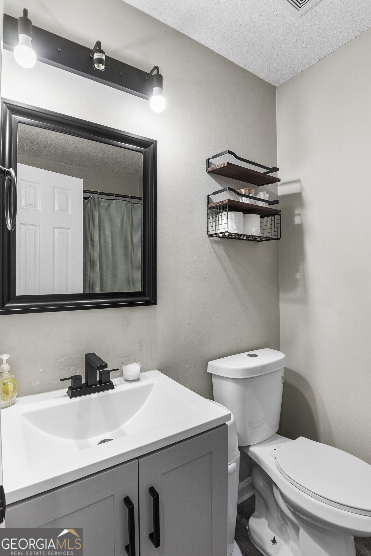 1412 Johnson Road Macon, GA 31220 - Photo 43 of 53 a bathroom with a toilet sink and mirror