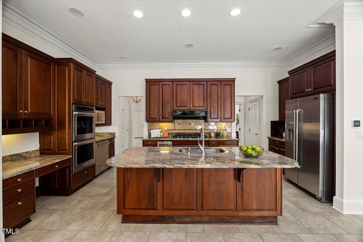4016 Edward Pride Wynd Raleigh, NC 27612 - Photo 14 of 69 a kitchen with stainless steel appliances granite countertop a stove a sink and a refrigerator
