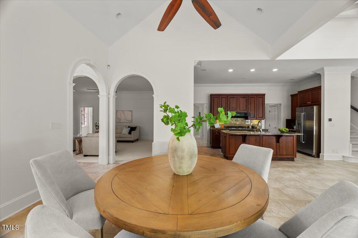 4016 Edward Pride Wynd Raleigh, NC 27612 - Photo 21 of 69 a dining room with furniture and a chandelier