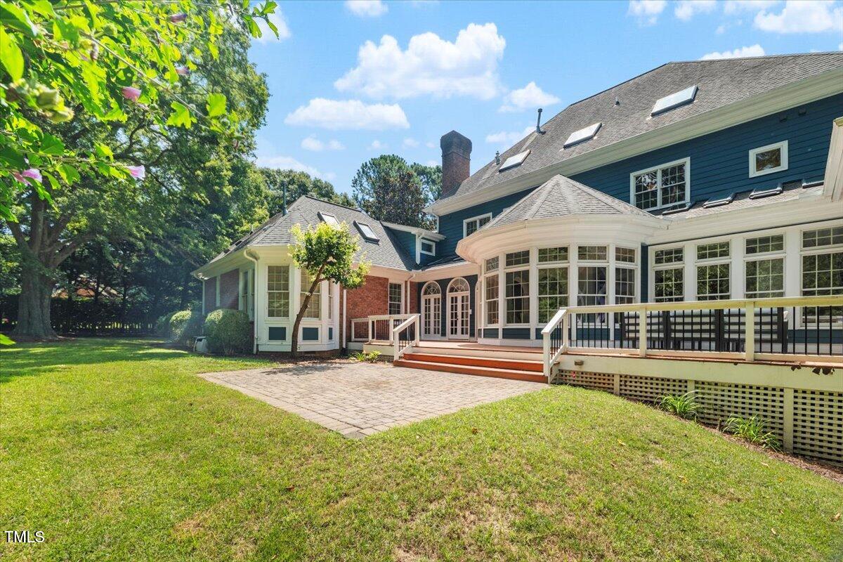 4016 Edward Pride Wynd Raleigh, NC 27612 - Photo 65 of 69 a front view of a house with a yard table and chairs