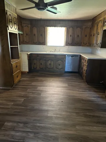a view of kitchen with granite countertop window and a sink