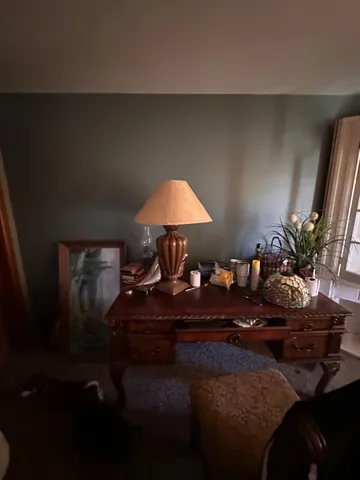 a living room with furniture and a lamp