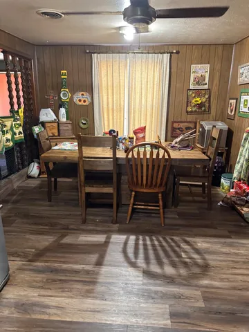 a living room with furniture a window and a flat screen tv