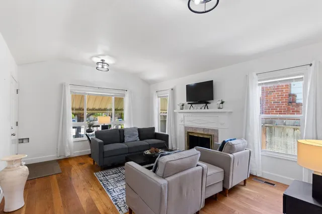 a living room with furniture fireplace and a flat screen tv