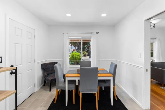 a dining room with furniture and a window