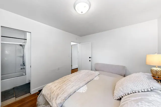 a bedroom with a bed and a lamp