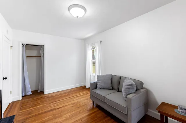 a living room with a couch and a window