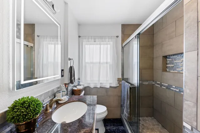 a bathroom with a sink toilet and shower