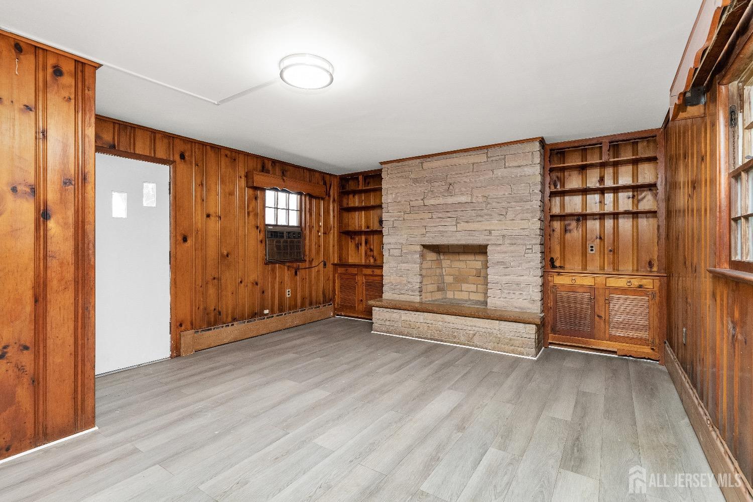 225 Kuser Road Hamilton, NJ 08619 - Photo 11 of 26 wooden floor fireplace and windows in an empty room