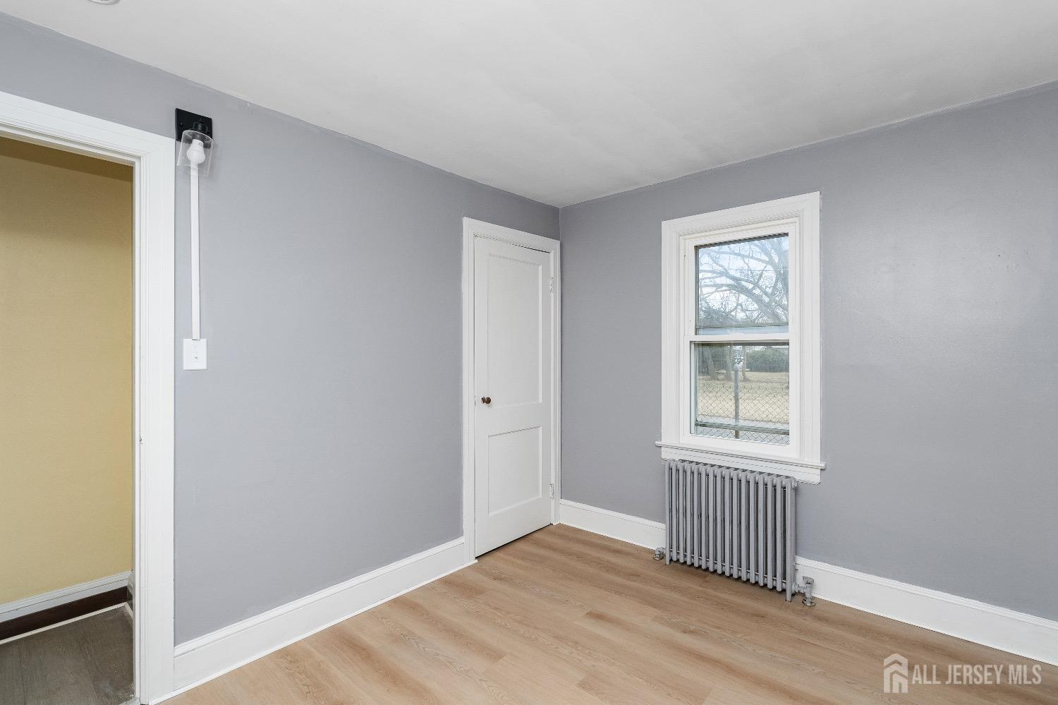 225 Kuser Road Hamilton, NJ 08619 - Photo 15 of 26 a view of an empty room with wooden floor and a window