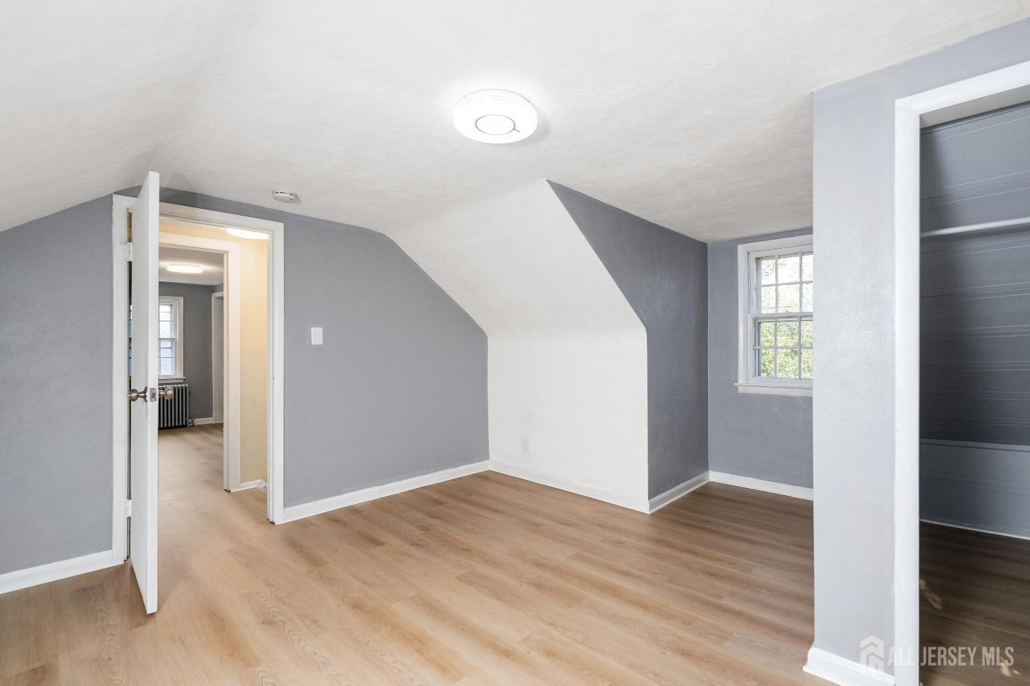 225 Kuser Road Hamilton, NJ 08619 - Photo 21 of 26 wooden floor in an empty room with a window