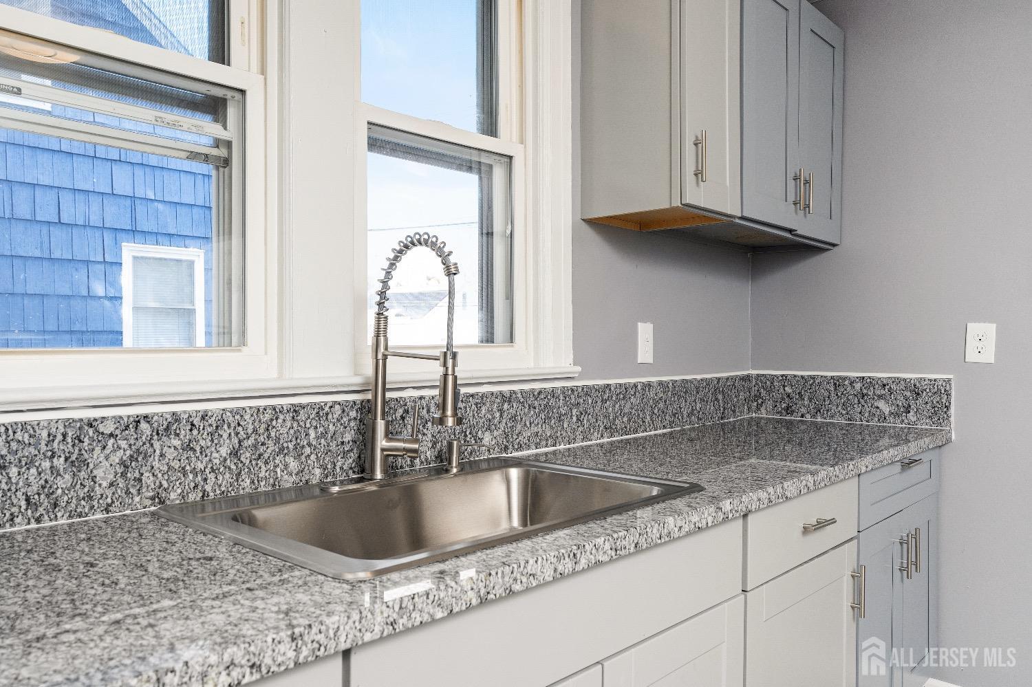 225 Kuser Road Hamilton, NJ 08619 - Photo 8 of 26 a kitchen with granite countertop a sink and a window
