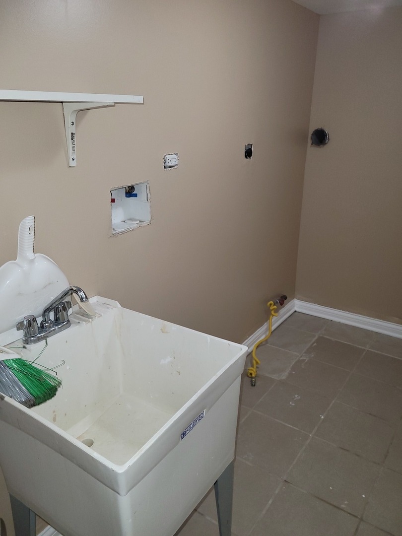8529 South Rhodes Avenue Chicago, IL 60619 - Photo 16 of 16 a bathroom with a sink and vanity