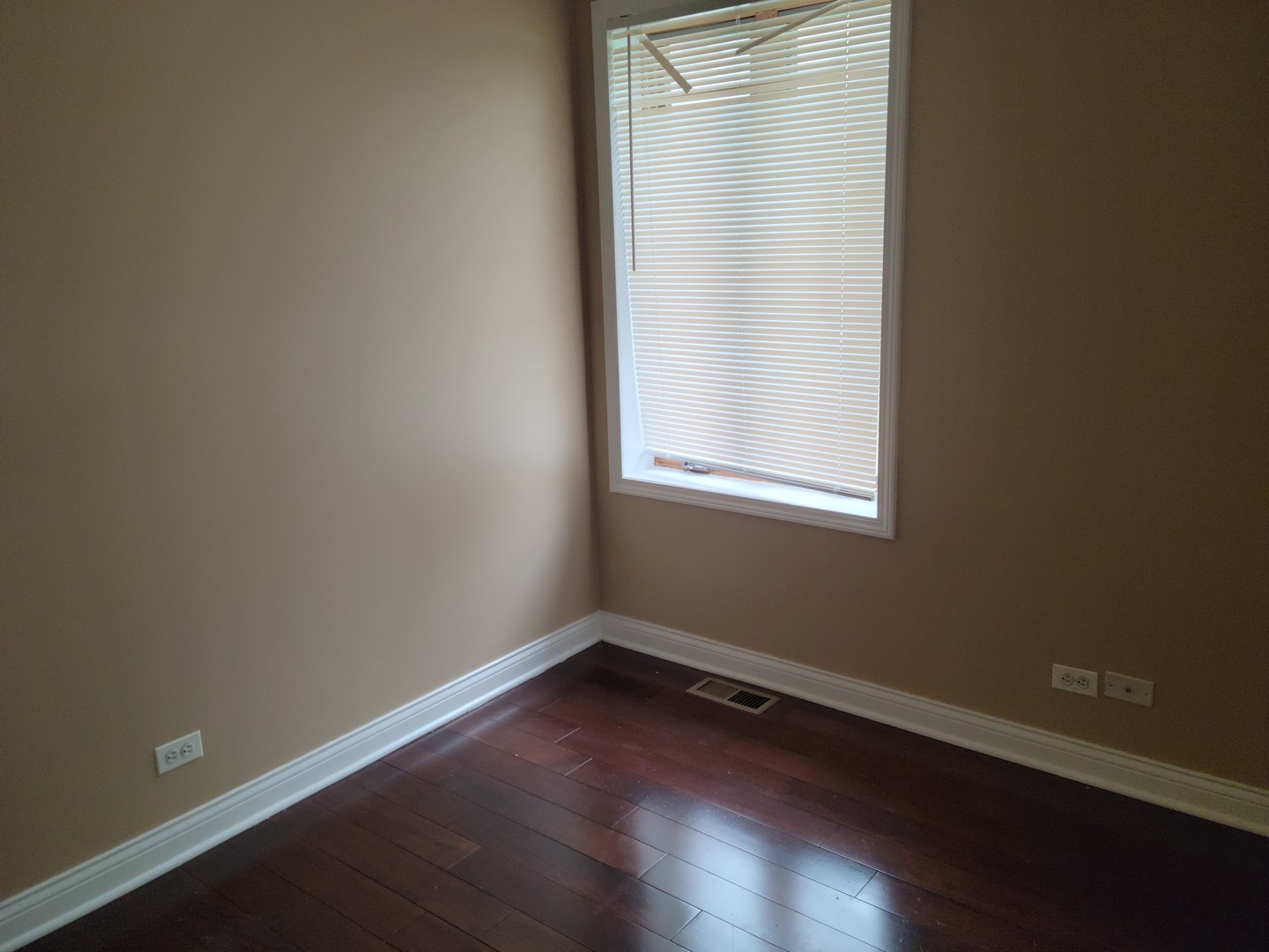 8529 South Rhodes Avenue Chicago, IL 60619 - Photo 6 of 16 a view of a small space with wooden floor and a window