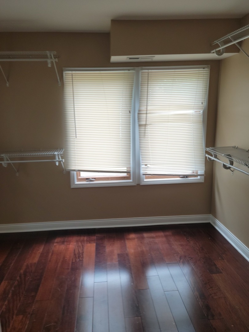 8529 South Rhodes Avenue Chicago, IL 60619 - Photo 7 of 16 a view of a room with wooden floors and a window