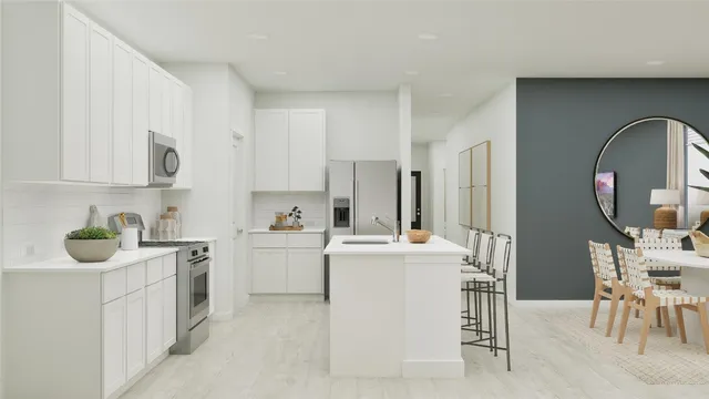 a kitchen with a sink a stove and white cabinets
