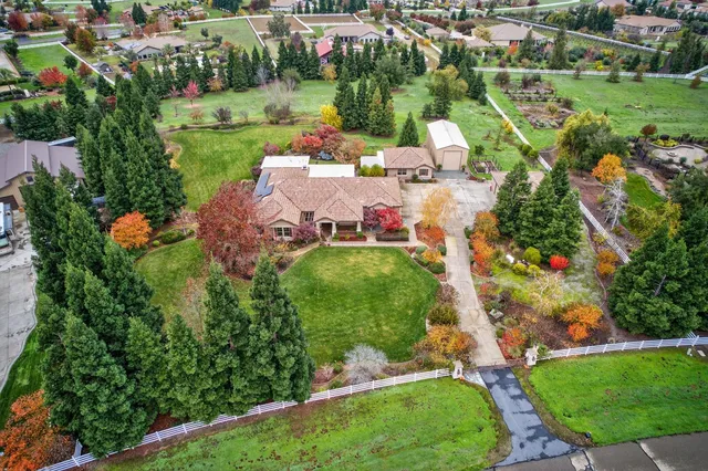 an aerial view of house with yard swimming pool and outdoor seating