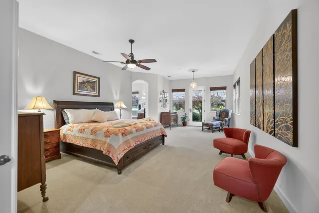 a view of a chair and table in backyard of the house