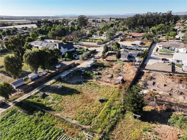 an aerial view of multiple houses with yard