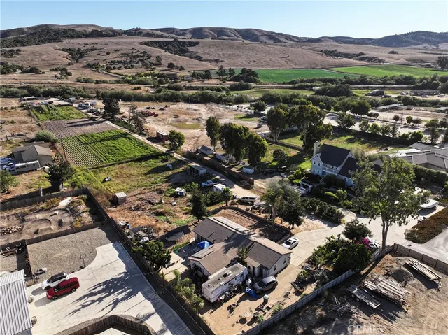 an aerial view of multiple houses with yard