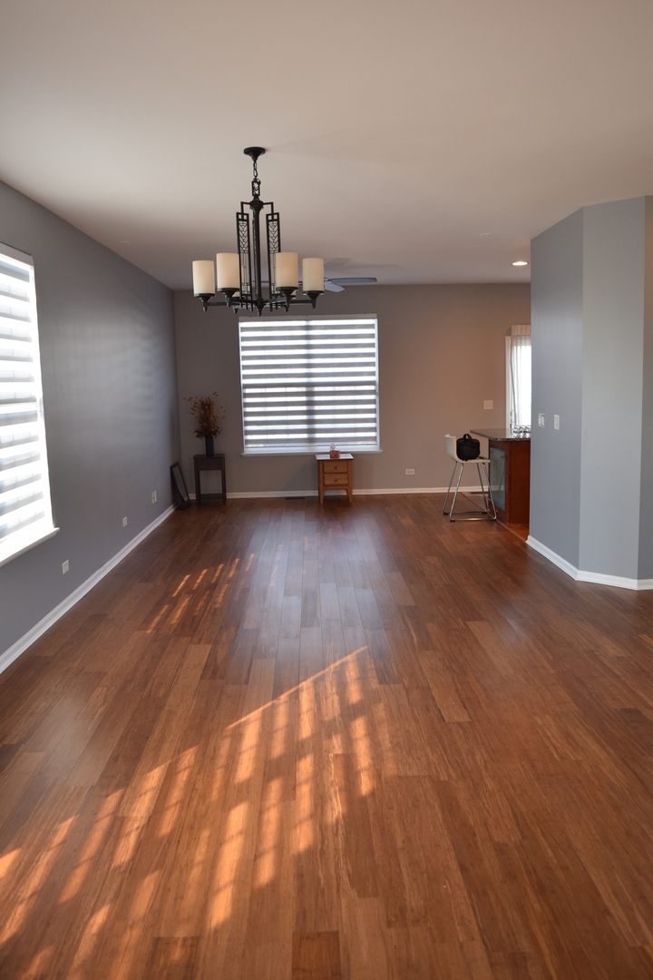 4110 Bethlehem Road Aurora, IL 60504 - Photo 12 of 53 an empty room with wooden floor and windows