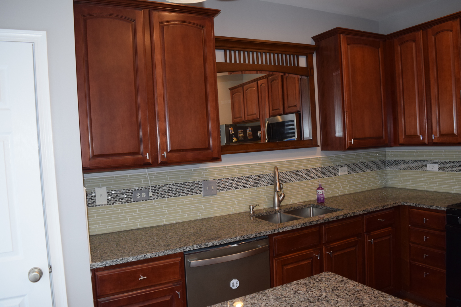4110 Bethlehem Road Aurora, IL 60504 - Photo 22 of 53 a kitchen with granite countertop stainless steel appliances a sink window and cabinets